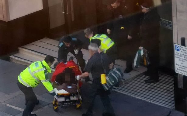Ambulance staff and victim on stretcher